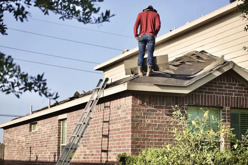 Professional roofer working on a residential roof in Sally Marshall Crossing